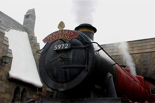 Hogwarts Express steam locomotive at Universal Orlando Resort, showcasing iconic train details and themed architecture.