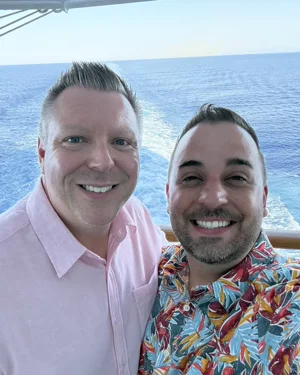 Sean Middlebrook, Disney and Disney Cruise Line travel advisor at Favorite Day Adventures, with his husband Bryan aboard a Disney cruise